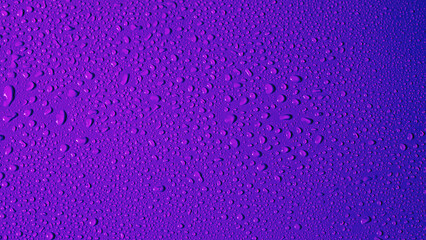 Purple background with water drops. Neon color with a gradient from magenta to blue. Copy Space.