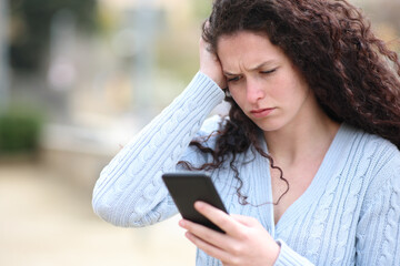 Worried woman checks smart phone content