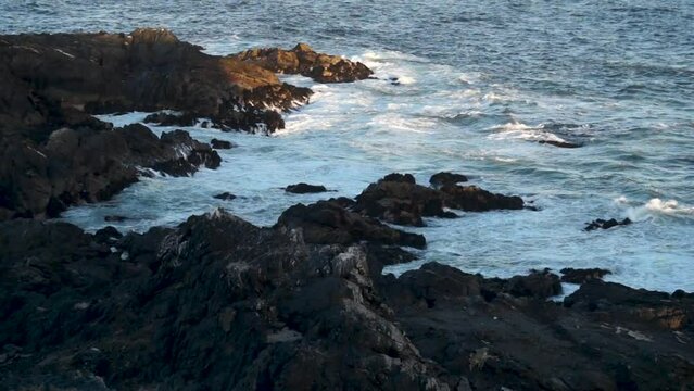 In the image can be seen how the sea waves hit some rocks in a coastal area in the north of Chile.