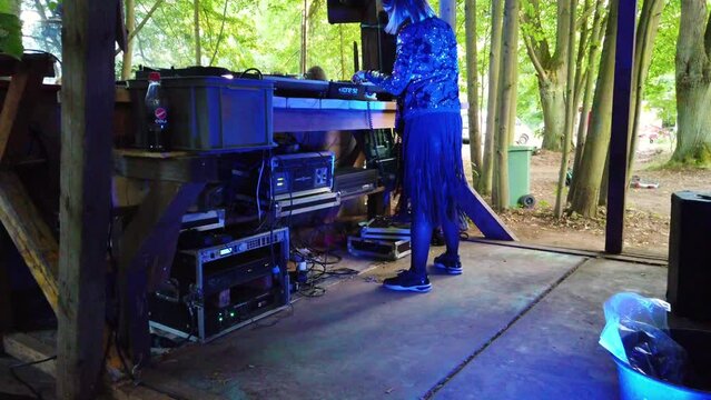 DJ artist plays favorite hits. filmed from the VIP area.
female Dj at work on a music festival rote dichte in the woods play techno. Shoot on a underground music party in forest by Philipp Marnitz