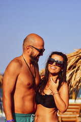 Obraz premium Beautiful Happy Couple hugging and kissing enjoying Vacation holidays a near the beach