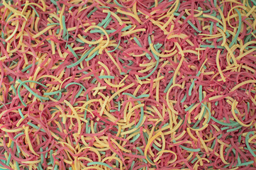 Noodles with colored vegetables. A close-up shot of colorful pasta sprinkled with flour