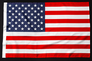 Fototapeta premium USA national flag on black background top view