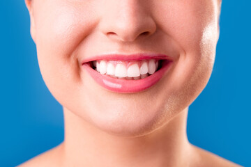 Obraz premium Healthy white smile close up. Beauty woman with perfect smile, lips and teeth. Beautiful Model Girl with perfect skin. Teeth whitening.