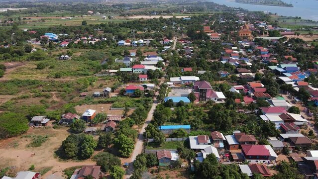 Drone footage above a rural village in Koh Okhna Tey island in Cambodia. Green fields and small houses along the Mekong river 2-2