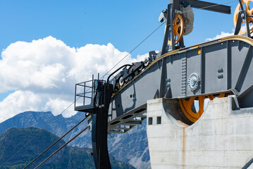 Detail of the engine of a cableway pulling machinery, with wheels, cables, concrete and steel...