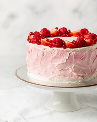Strawberry cake, strawberry sponge cake with fresh strawberries and sour cream on a white background