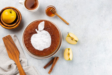 Homemade apple pie on a white wooden background, top view. The classic autumn dessert for Thanksgiving is organic apple pie.
