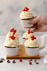 Vanilla cupcakes on white wood background, copy space