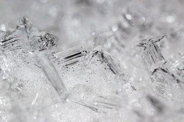 Transparent frozen small ice pieces. Abstract full frame background.