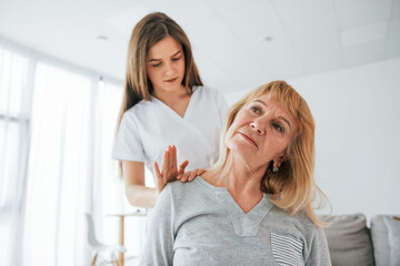 Neck massage. Senior woman is visiting physician in the office