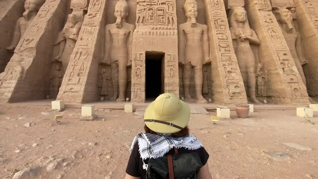 back view of woman standing in front of Abu Simbel temple in Aswan Egypt