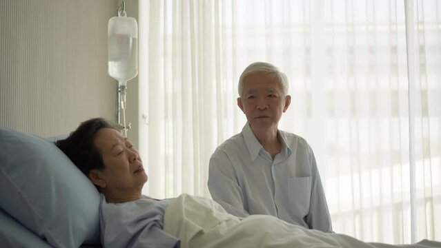 happy relax Asian senior couple in hospital talking smile laugh while recovery