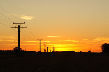 Power line at sunrise. Sunrise in the field.