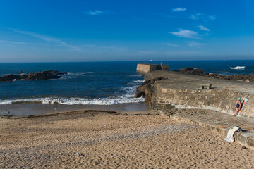 beach and rock and woman sunbathing in Foz do Douro, Porto, Portugal