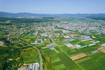 Fototapeta premium Panoramic view from the heights, industrial villages, where there are many farm greenhouses.