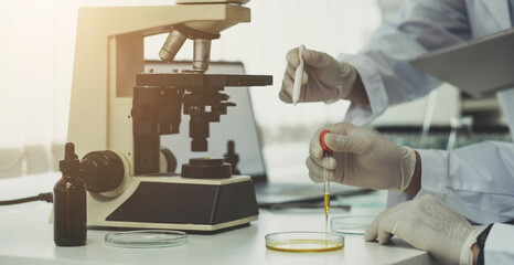Closeup Woman medical scientist and researchers teamwork analyzing innovative virus protective vaccines in health care biology laboratory
