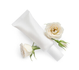 Obraz na płótnie Canvas Tube of hand cream and roses on white background, top view