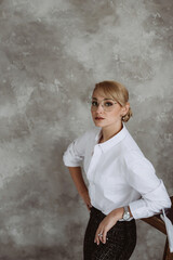 Beautiful middle aged business woman in glasses standing over isolated white background with a happy and cool smile on her face. Happy man. Soft selective focus.