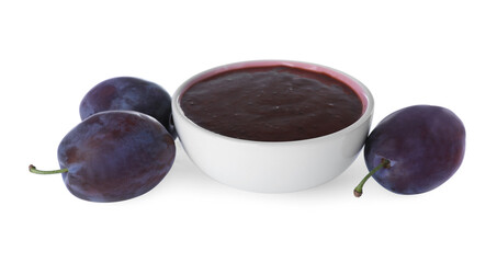 Plum puree in bowl and fresh fruits on white background