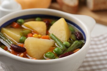 Bowl of delicious turnip soup on table, closeup view