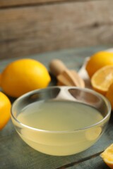 Freshly squeezed lemon juice in glass bowl on table