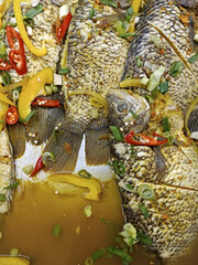 fresh raw indonesia asia carp fish with spices ready to cook