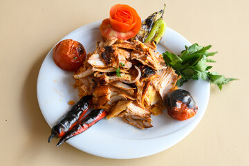 Turkish and Arabic Traditional Ramadan doner kebab with tasty tomato sauce and rice or turkish pilav in white plate on wood table background. ( Pilav ustu doner)