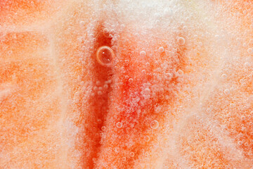 Fototapeta premium Half of red ripe strawberry with a bubble. Close-up. Macro.