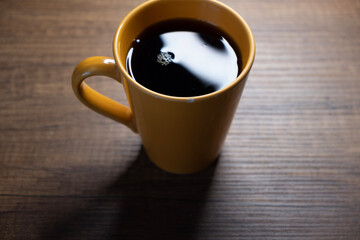 macro shot of filter coffee and orange coffee mug