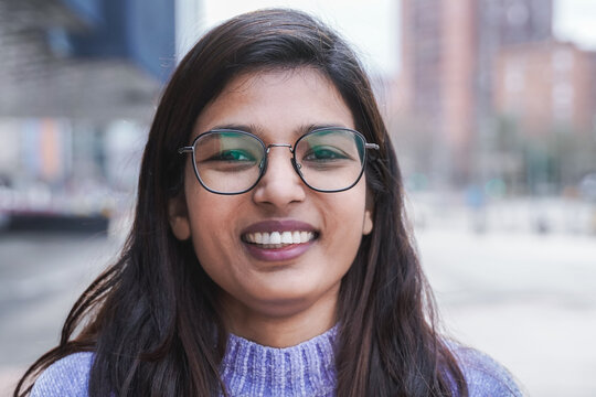 Happy Indian girl smiling on camera outdoor - Focus on face