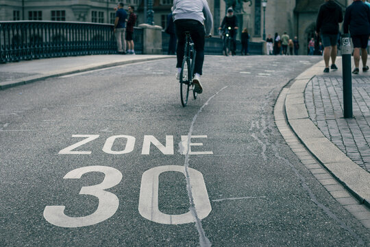 speed limit sign on street, bicycle on road at area of zone 30 speed limit