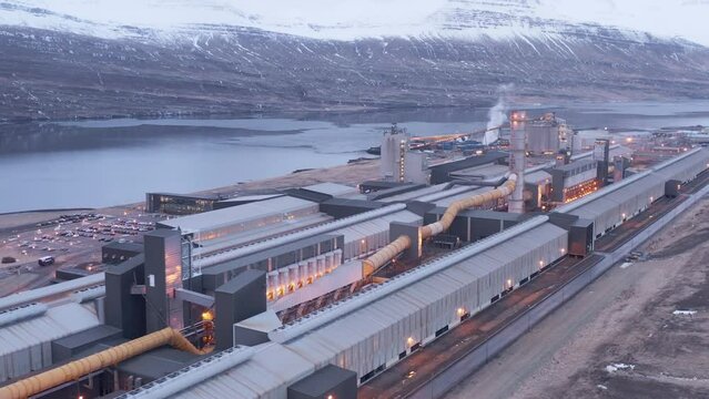 Massive aluminium factory on shore of Icelandic fjord, aerial
