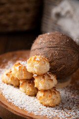 Coconut cookies. Homemade gluten free pastry with coconut. Small round sweets on a wooden table. High quality photo. Copy space