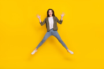 Fototapeta na wymiar Full body photo of delighted overjoyed lady jumping up have fun during summer vacation isolated on yellow color background