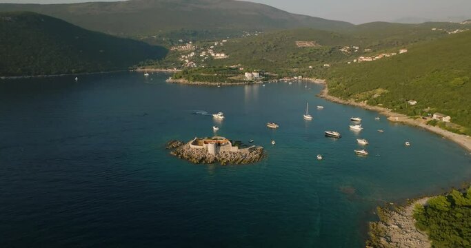 aerial view of Otocic Gospa island and yachts on bacground