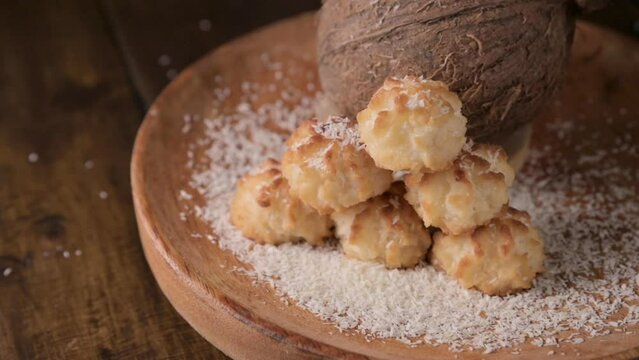 Coconut cookies. Homemade gluten free pastry with coconut. Small round sweets on a wooden table. High quality photo. real coconut are pouring