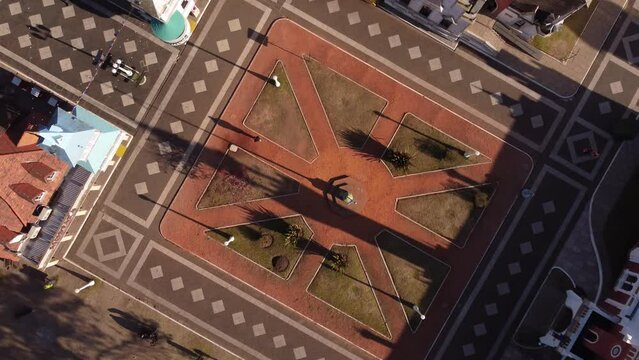 People walking in small square of Republica de Los Niños or children republic in Argentina. Aerial drone top-down circling view