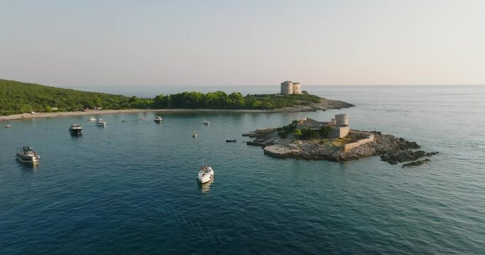 passing by Otocic Gospa island with boats and yachts