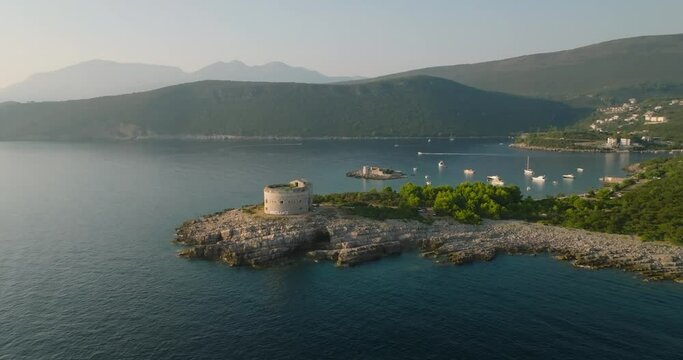 moving away from fort arza and Otocic Gospa island with boats and yachts on background