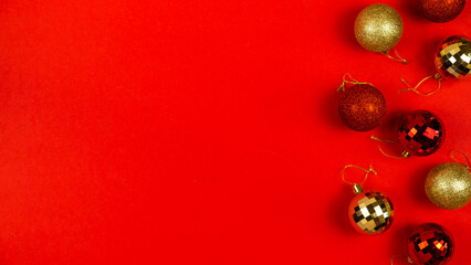Christmas balls on red background. Top view, text space. Banner