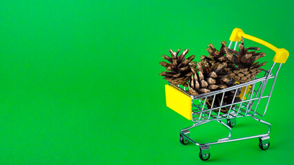 Christmas bumps in a small trolley on green background. Bumps in a trolley. Copy space