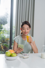  young woman typing a text message on mobile phone