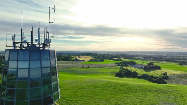 Panoramic view of farmers' fields, sunset and observation tower.