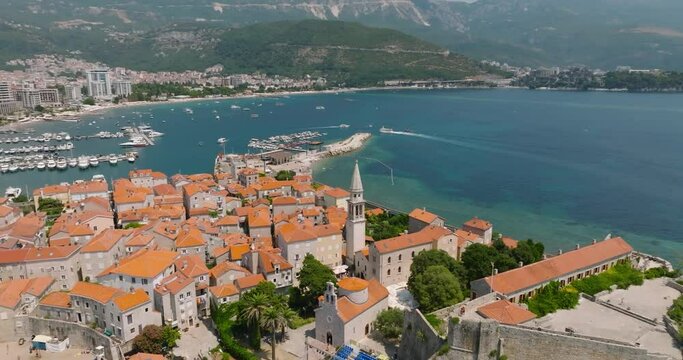 orbit aerial view of old town budva with chusch and adriatic sea