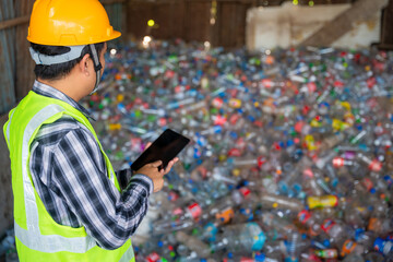 A workers work on recycle waste, Recycling Analyst looking at recycling waste To proceed to the...