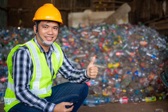A workers work on recycle waste at recycling factory.