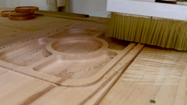 CNC router machine cutting on the wooden board. Cnc industry concept with cutting wood.