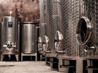 Stainless wine barrels in old vineyard cellar - obrazy, fototapety, plakaty