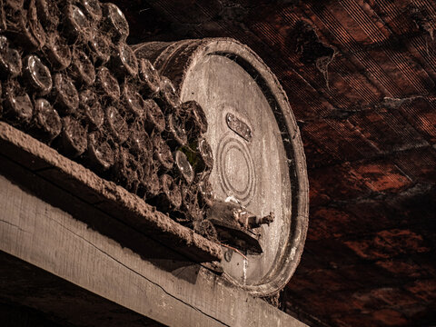 Wooden barrel with staked wine bottles on the side